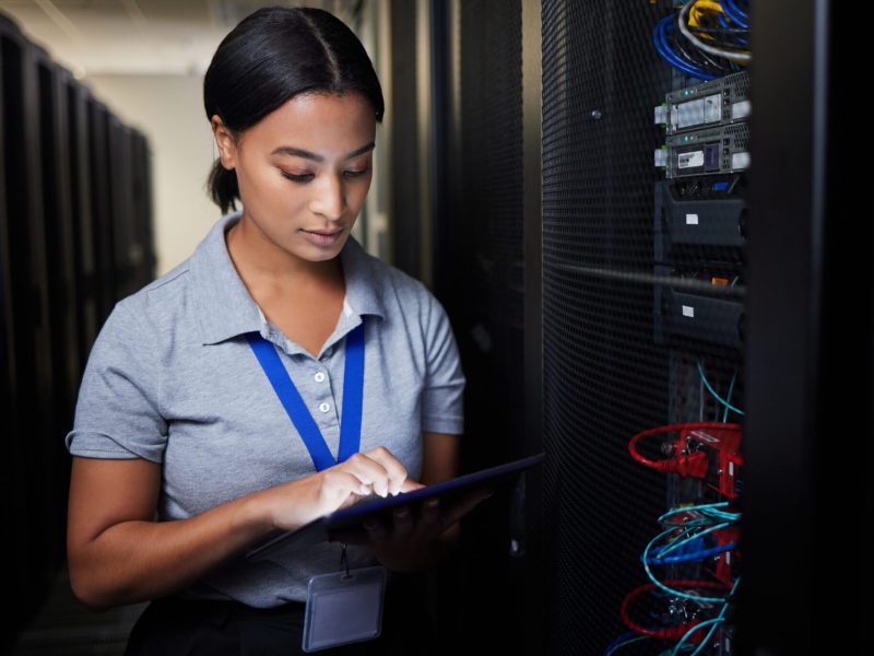 Woman, tablet and server room, programming or coding for cybersecurity, information technology or d.